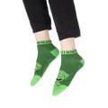 Focus on the blue contrasting cuff of the Cookie Monster sock with partial text visible.