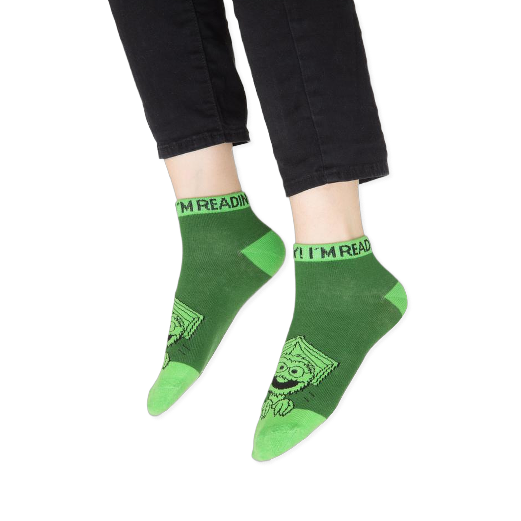 Focus on the blue contrasting cuff of the Cookie Monster sock with partial text visible.