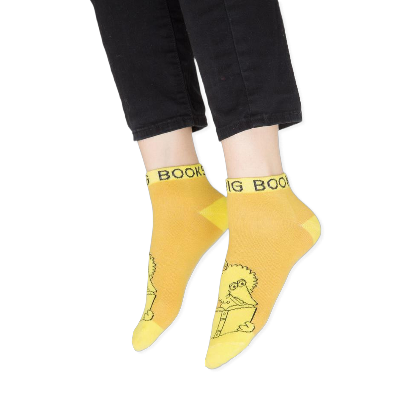 Flat lay of the four vibrant Sesame Street ankle socks displayed against a black background.
