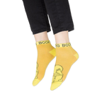 Flat lay of the four vibrant Sesame Street ankle socks displayed against a black background.