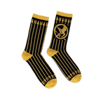 Black crew socks featuring vertical gold arrows, a gold Mockingjay symbol, and contrasting gold cuffs and toe blocks.