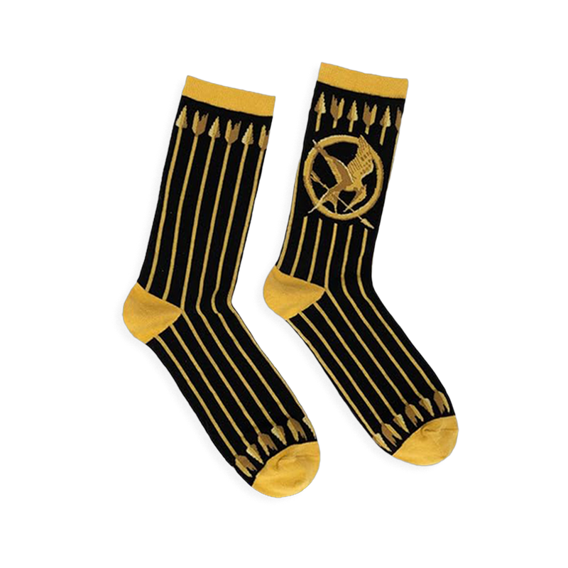 Black crew socks featuring vertical gold arrows, a gold Mockingjay symbol, and contrasting gold cuffs and toe blocks.