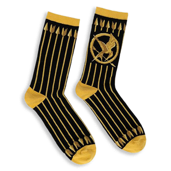 Black crew socks featuring vertical gold arrows, a gold Mockingjay symbol, and contrasting gold cuffs and toe blocks.