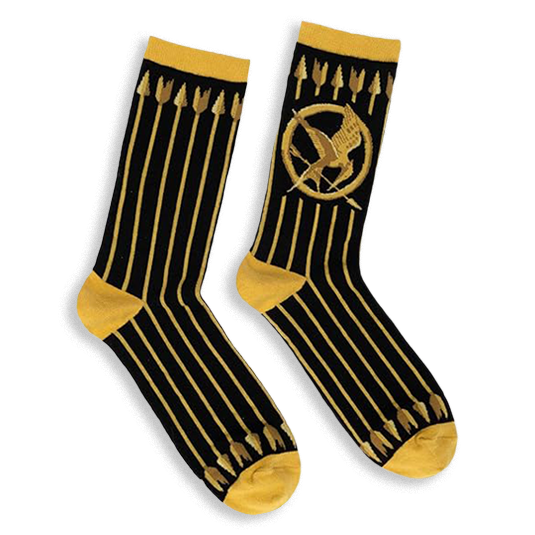 Black crew socks featuring vertical gold arrows, a gold Mockingjay symbol, and contrasting gold cuffs and toe blocks.