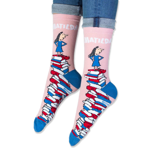 Close-up of the pink sock cuff showing bold white MATILDA text and the illustration of the girl.
