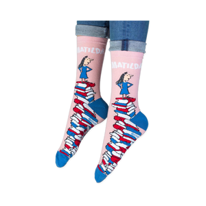 Close-up of the pink sock cuff showing bold white MATILDA text and the illustration of the girl.