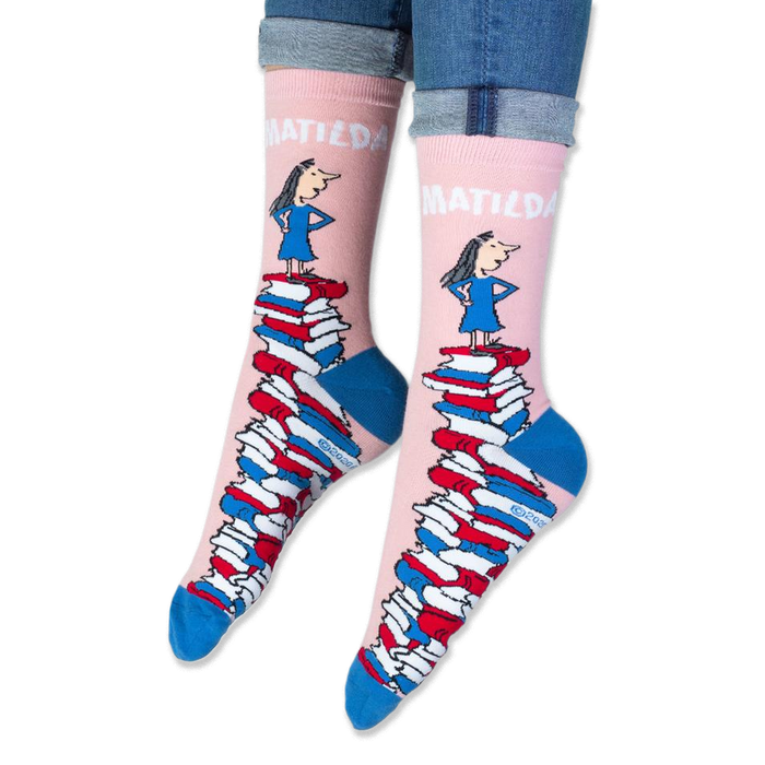 Close-up of the pink sock cuff showing bold white MATILDA text and the illustration of the girl.