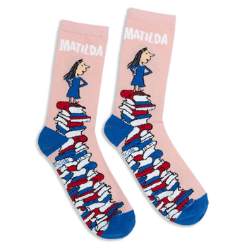 Pink crew socks with blue heels and toes, featuring Matilda standing on a giant tower of colorful books.