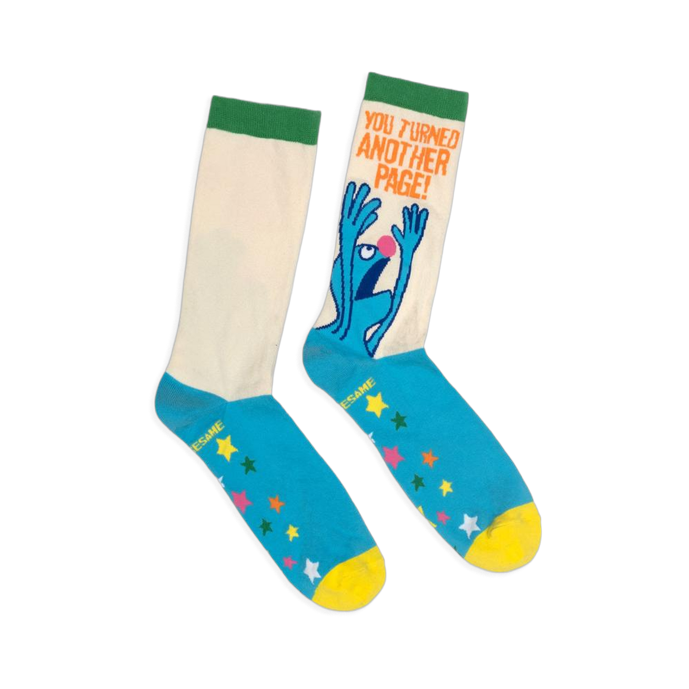 Flat lay of crew socks with a cream shaft, green cuff, blue foot, yellow toe, colorful stars, and panicked Grover graphic.