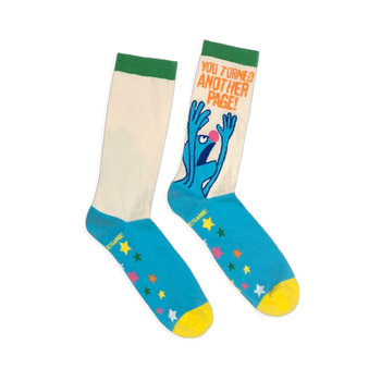 Flat lay of crew socks with a cream shaft, green cuff, blue foot, yellow toe, colorful stars, and panicked Grover graphic.