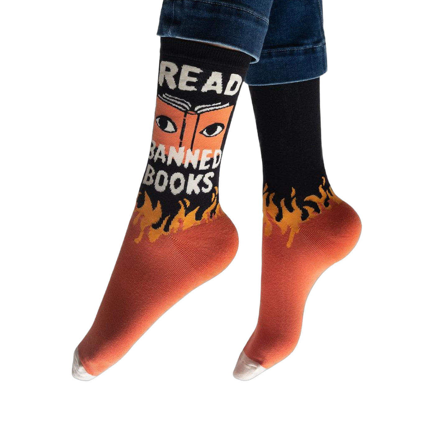 Person wearing the black and orange Read Banned Books socks, showing the white text and eye graphic facing forward.