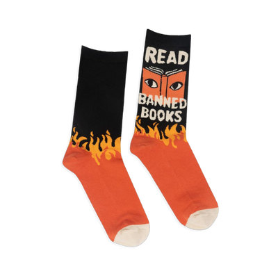 Black and orange crew socks with yellow flames. One shows an open book with eyes and the text READ BANNED BOOKS in white.