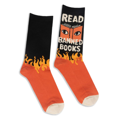Black and orange crew socks with yellow flames. One shows an open book with eyes and the text READ BANNED BOOKS in white.