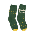 Pair of women's crew socks in forest green with small yellow flower pattern and 'Book Babe' text on one sock. Yellow heel and toe.
