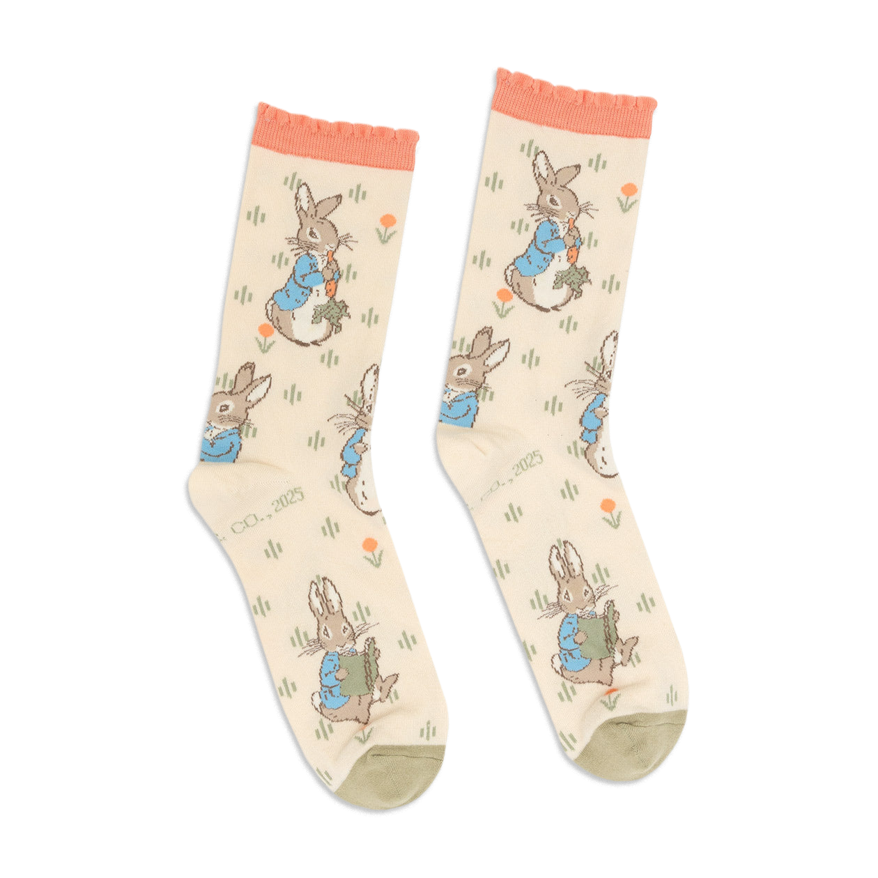 Pair of Peter Rabbit crew socks in light beige, with peach ruffled cuffs and olive green toes, standing upright.