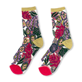 Sheer socks displaying bright flowers, green leaves, magenta toes, solid heels, and sparkly gold cuffs on a dark background.
