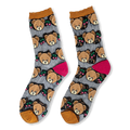 Flat lay of sheer mesh socks with opaque teddy bear faces, red cherries, mustard ruffled cuffs, and bright pink heels.