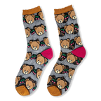 Flat lay of sheer mesh socks with opaque teddy bear faces, red cherries, mustard ruffled cuffs, and bright pink heels.