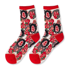 Flat lay of sheer mesh socks with opaque teddy bear faces, red cherries, mustard ruffled cuffs, and bright pink heels.