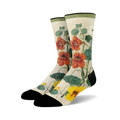 Pair of crew socks with a botanical print.  Features orange and yellow nasturtium flowers and green leaves on a cream background. Black toe and heel.