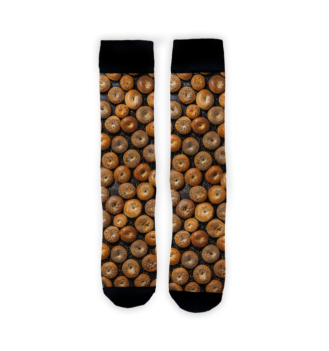 A pair of socks with a pattern of bagels on a black background.