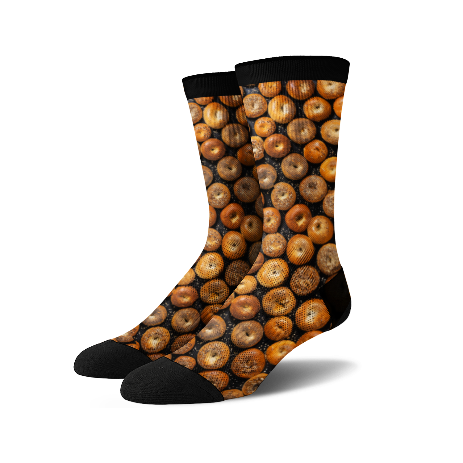 A pair of crew socks with a full-coverage print of various bagels in shades of brown and tan on a black background.