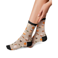 Lifestyle shot of a model wearing Pumpkin Spice Latte socks, showing how they look on.