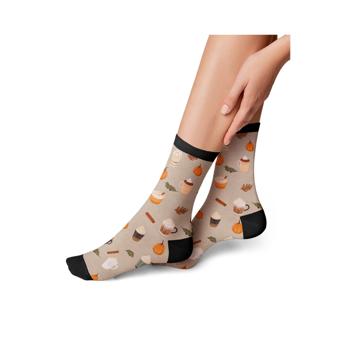 Lifestyle shot of a model wearing Pumpkin Spice Latte socks, showing how they look on.