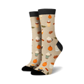 Pair of cream crew socks with a repeating pattern of pumpkins, coffee cups, and cinnamon sticks. Black cuffs.