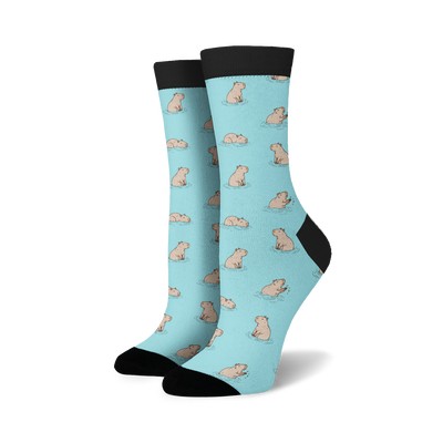 Pair of crew socks in pastel blue with a repeating pattern of illustrated capybaras in the water.