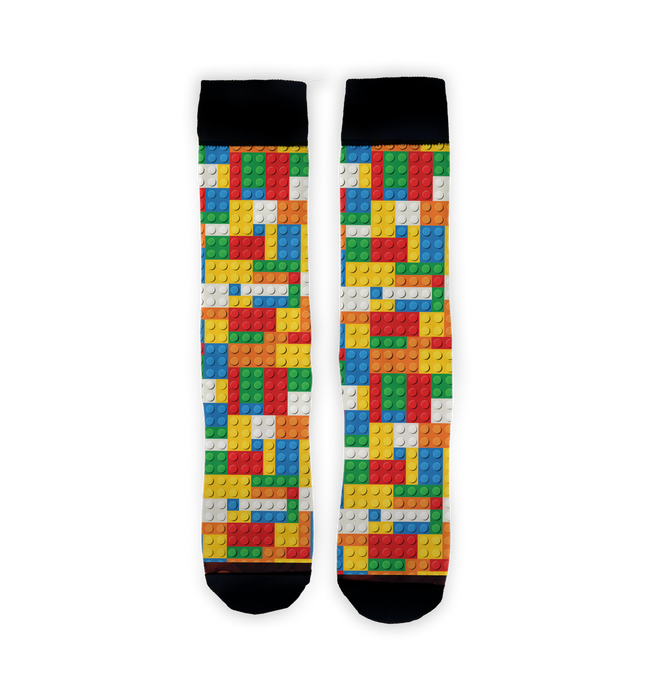 A pair of black socks with a colorful pattern of Lego bricks.