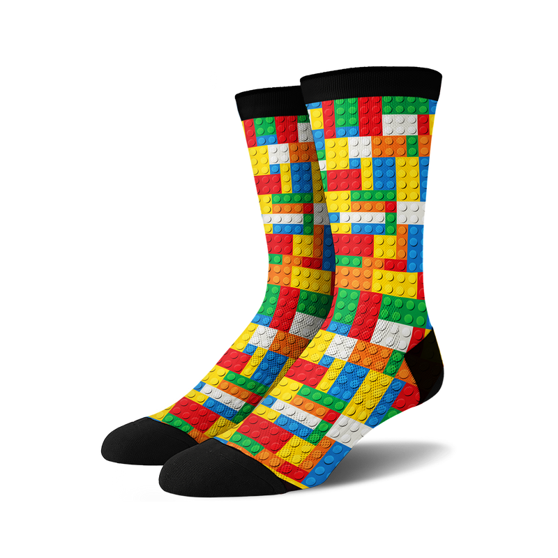 Pair of crew socks with a Lego-inspired design.  The socks are predominantly red, yellow, blue, and white, with a black cuff.