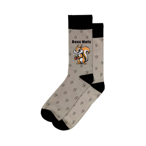 A pair of socks with a pattern of brown acorns on a light gray background. The top of the sock is black with white text that reads 