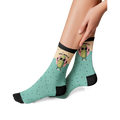 Lifestyle photo showing the 'Just Dill With It' socks on a person's feet. The socks are teal with a pickle design.