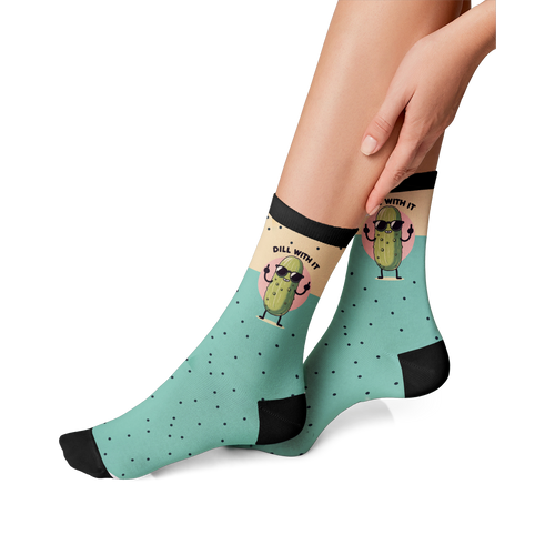 Lifestyle photo showing the 'Just Dill With It' socks on a person's feet. The socks are teal with a pickle design.