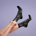 Flat lay: Pair of beige 'Dead Man's Party' socks. [lf]