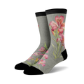 Pair of crew socks in grey with a pink and white Alstroemeria lily design. The socks have a black cuff.