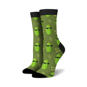 A pair of green socks with a pattern of cartoon cucumbers wearing sunglasses and giving the middle finger. The socks have black toes and heels.