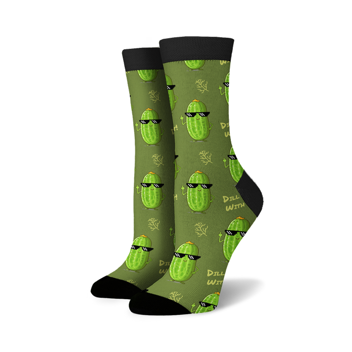 A pair of green socks with a pattern of cartoon cucumbers wearing sunglasses and giving the middle finger. The socks have black toes and heels.