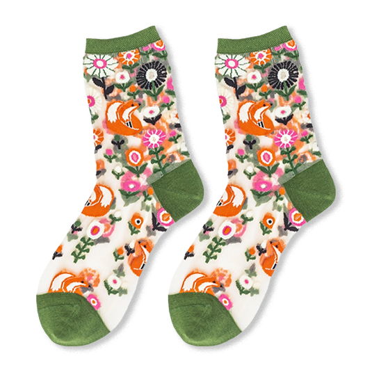 Flat lay of sheer crew socks with an orange fox and pink floral pattern, featuring solid olive green trims on the ends.