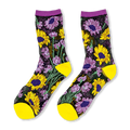 Sheer black socks with yellow sunflowers and purple flowers, featuring solid yellow toes, heels, and purple cuffs.