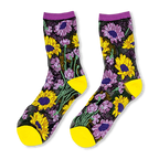 Sheer black socks with yellow sunflowers and purple flowers, featuring solid yellow toes, heels, and purple cuffs.