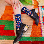 Close up of sheer crew socks highlighting the translucent mesh fabric and the solid royal blue heel, toe, and cuff details.