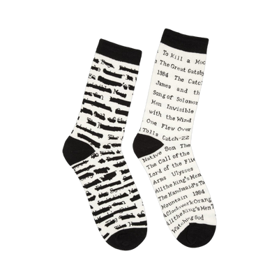Pair of cream crew socks with black stripes and text. Titles of banned books are printed on the socks, including 'To Kill a Mockingbird' and '1984'.