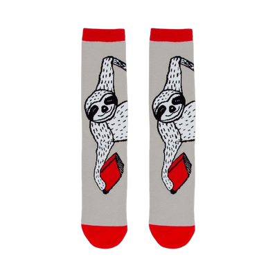 gray crew socks w/red cuff. sloth pattern printed in black and white, holding red books.   