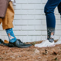 A friend in The Dogtor Is In socks in Blue kneels to comfort a nervous puppy, her white sneakers visible. [lf]