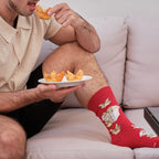 A close-up of Crab Rangoon socks in Red featuring crab rangoon illustrations, on a person seated at a Chinese-takeout dinner. [lf]