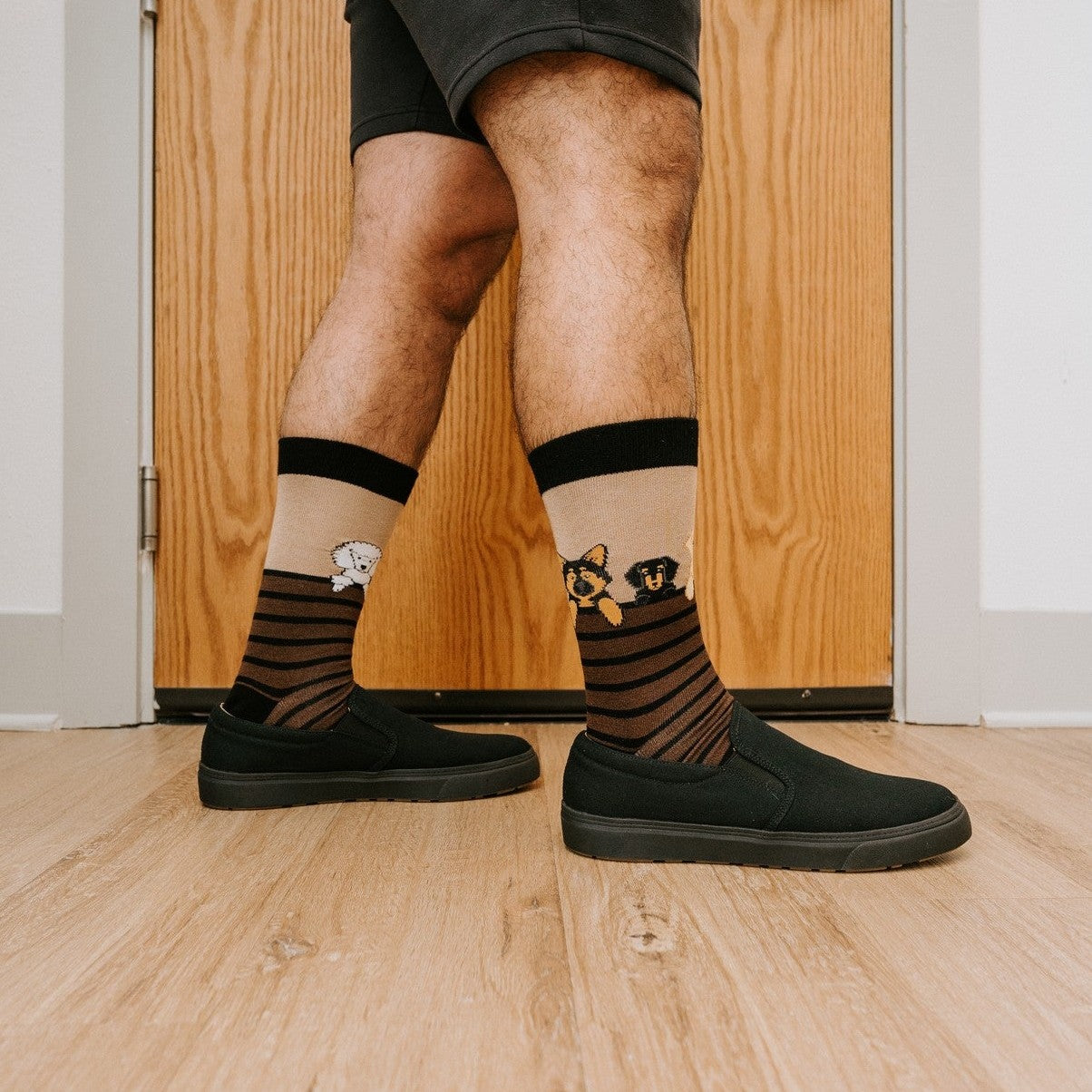 A pair of Dog Gone Stripes Bamboo socks in Hemp resting on a porch swing beside a dozing pug. [lf]