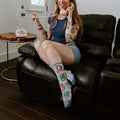 A whimsical interior portrait featuring Cat Calls light blue cat phone socks. [lf]
