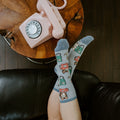A close-up of Cat Calls socks featuring kittens with vintage phones on a light blue knit. [lf]